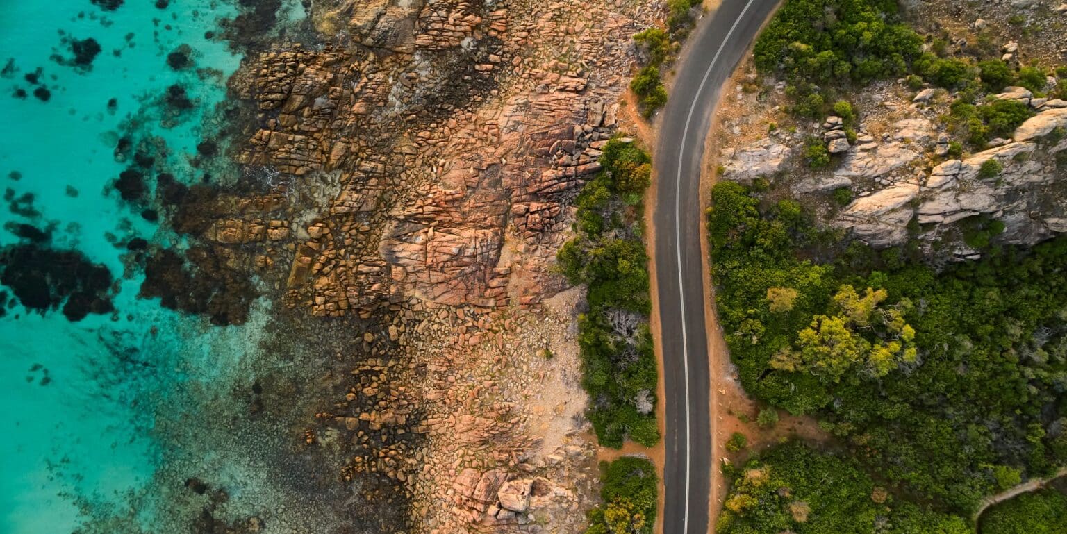 A road winding along next to the ocean