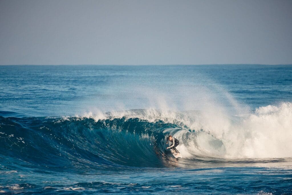 A man riding the barrel of a wave.